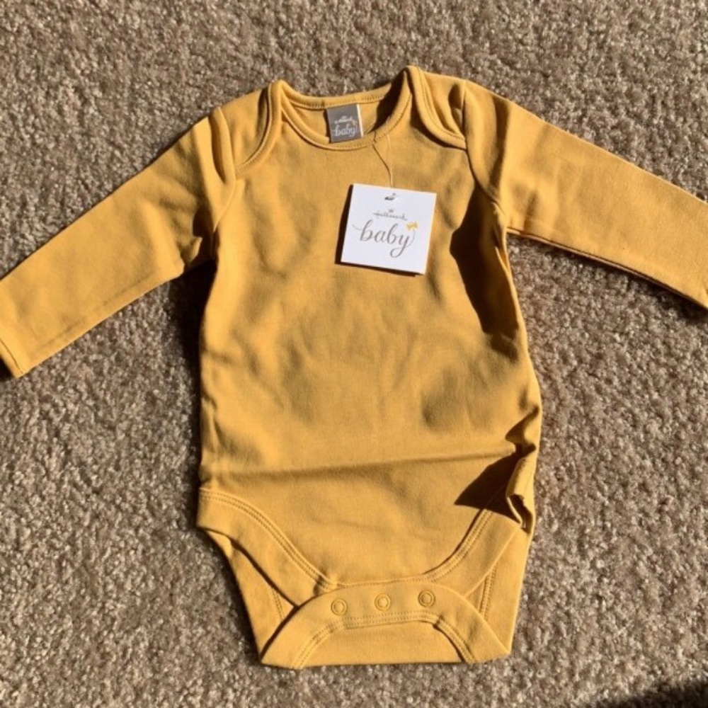 Mustard yellow baby onesie. Size 0-3 months.